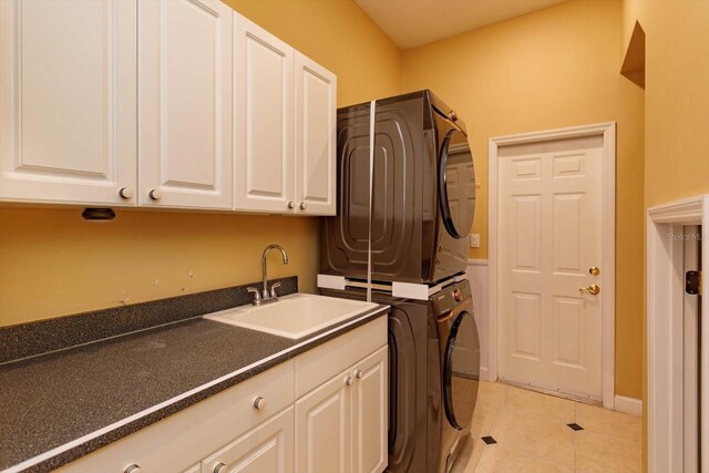 1704 Kersley Cir, Lake Mary, FL 32746 - clothes washing area with stacked washer / drying machine, cabinet space, a sink, and light tile patterned floors