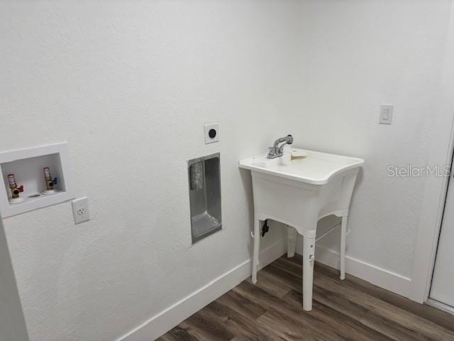 laundry area with hookup for a washing machine, dark wood-type flooring, electric dryer hookup, laundry area, and baseboards