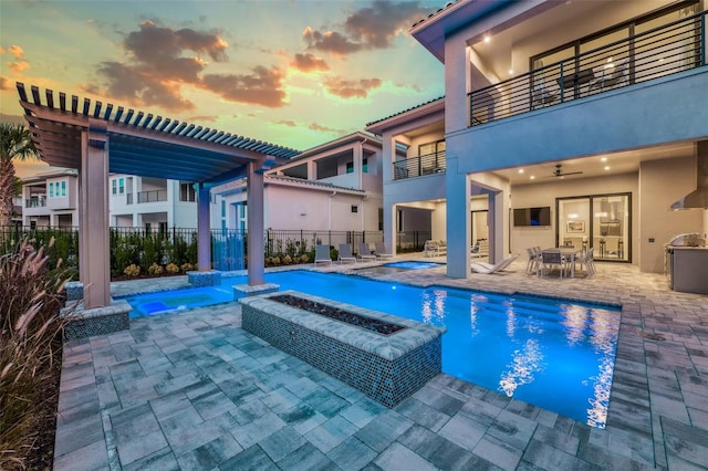 view of swimming pool featuring a fenced in pool, an in ground hot tub, fence, a patio area, and a pergola