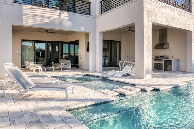 pool featuring exterior kitchen, a grill, a patio, and a ceiling fan