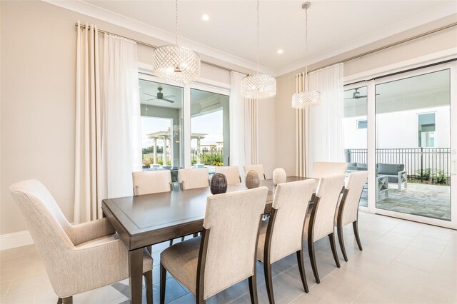 dining room with baseboards, crown molding, and recessed lighting