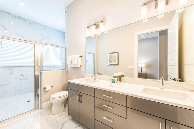 full bath featuring marble finish floor, a sink, a marble finish shower, and toilet