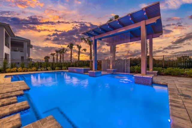 pool at dusk featuring a fenced in pool and fence