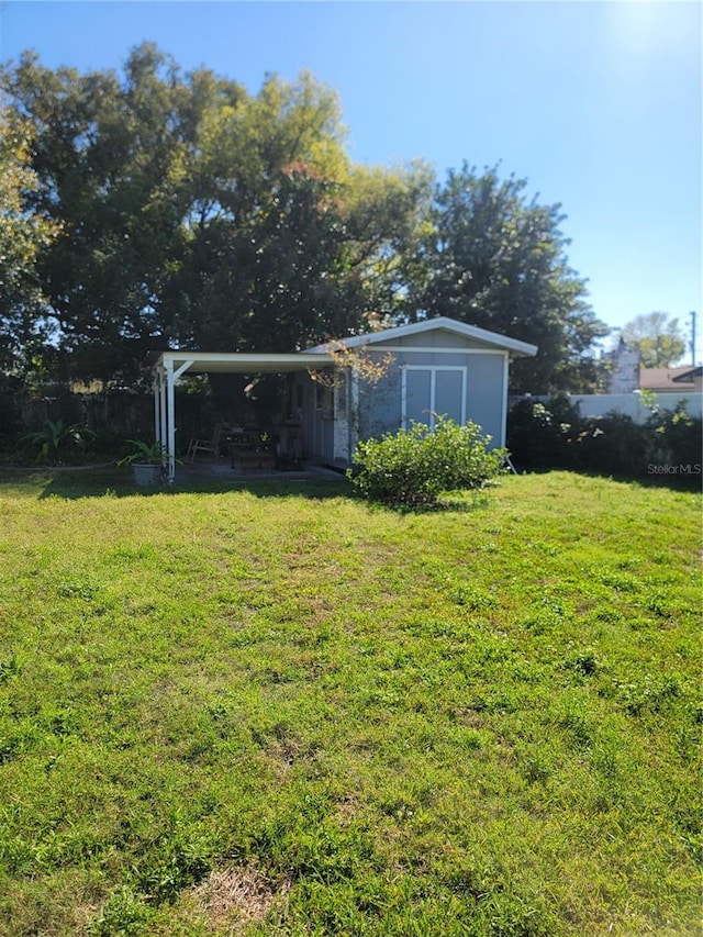 view of yard with an outdoor structure and a shed