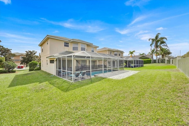 210 Vista Loop, Davenport, FL 33897 - rear view of property with a yard, a patio area, glass enclosure, and stucco siding