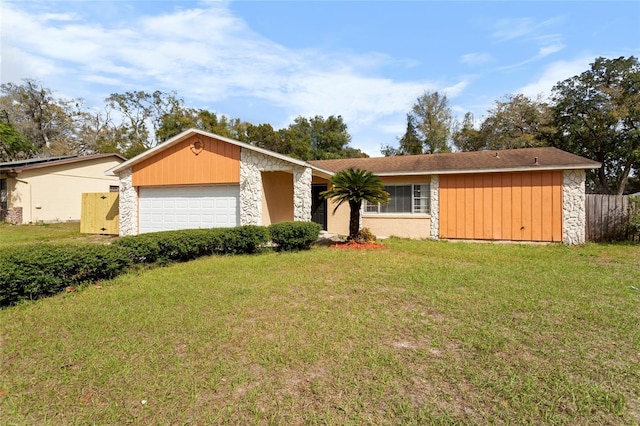 mid-century modern home featuring an attached garage, stone siding, and a front lawn