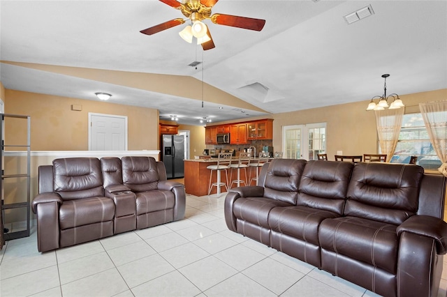 living room with light tile patterned floors, vaulted ceiling, plenty of natural light, and visible vents