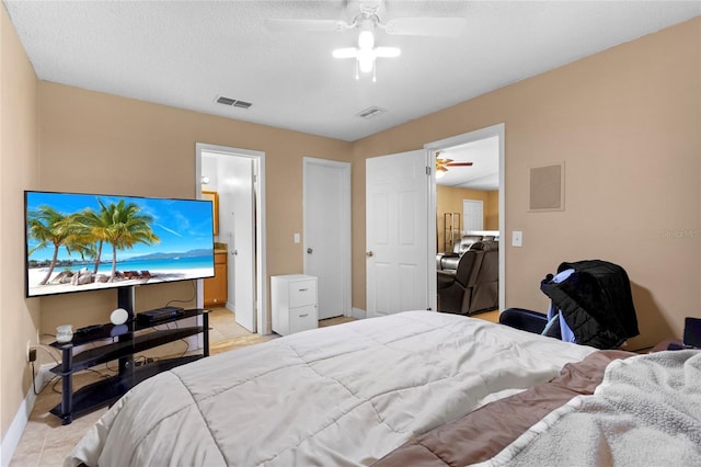 bedroom featuring ceiling fan, a textured ceiling, visible vents, and baseboards