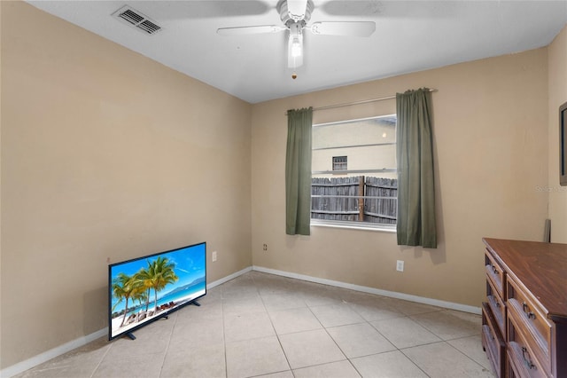 unfurnished bedroom with light tile patterned floors, baseboards, visible vents, and ceiling fan