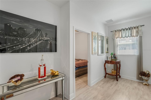 hall with wood finished floors and baseboards