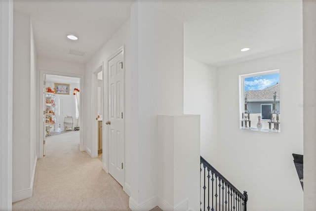 hallway with baseboards, carpet floors, an upstairs landing, and recessed lighting