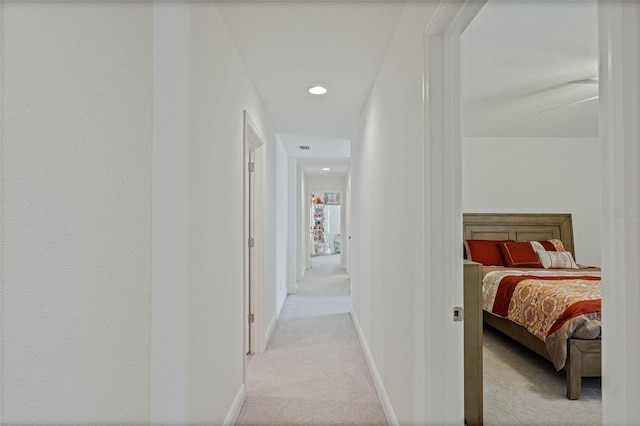 hall with carpet and baseboards