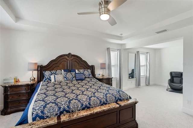 bedroom with visible vents, ceiling fan, light carpet, and baseboards