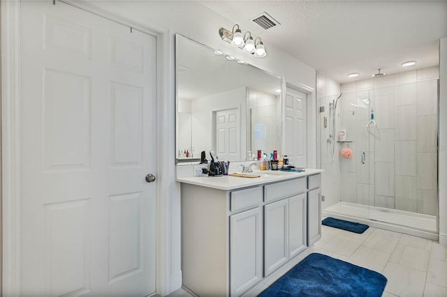 full bath featuring visible vents, a shower stall, and vanity