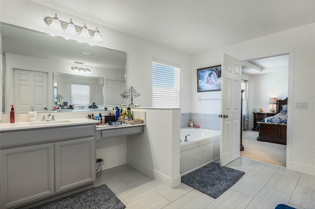 ensuite bathroom with a garden tub, baseboards, connected bathroom, and vanity