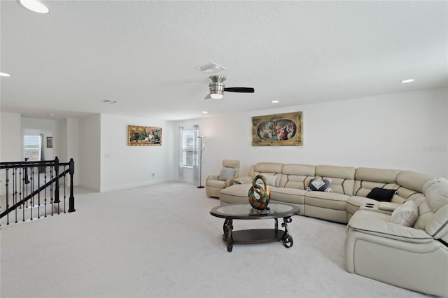 carpeted living room featuring a textured ceiling, recessed lighting, a ceiling fan, baseboards, and visible vents