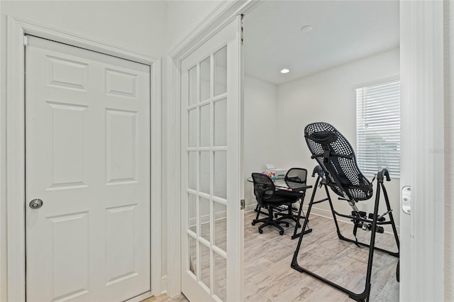 office space featuring light wood-type flooring and baseboards