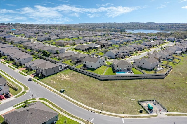 bird's eye view featuring a residential view and a water view