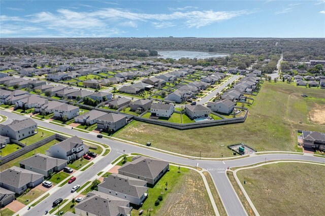 birds eye view of property with a water view and a residential view