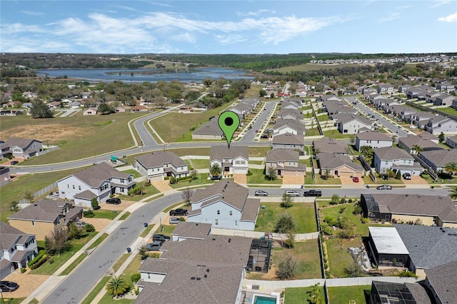 birds eye view of property featuring a residential view and a water view