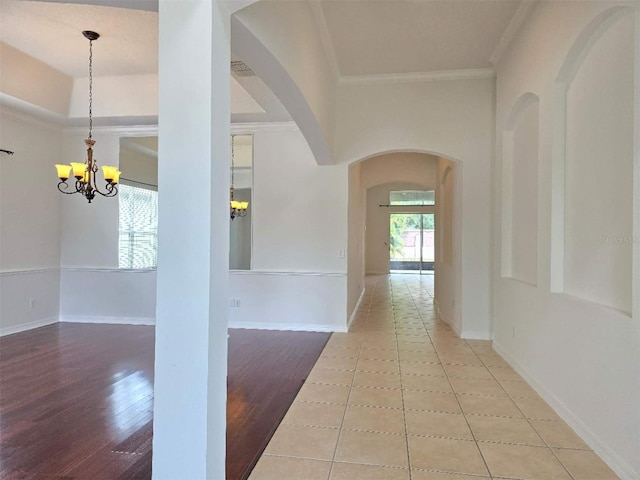 13413 Zori Ln, Windermere, FL 34786 - corridor with arched walkways, a chandelier, crown molding, and wood finished floors