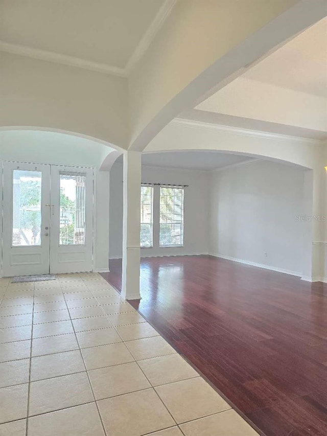13413 Zori Ln, Windermere, FL 34786 - empty room with arched walkways, healthy amount of natural light, light tile patterned floors, and ornamental molding