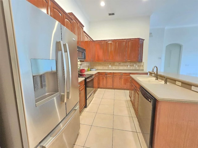 13413 Zori Ln, Windermere, FL 34786 - kitchen featuring appliances with stainless steel finishes, light tile patterned flooring, light countertops, backsplash, and recessed lighting