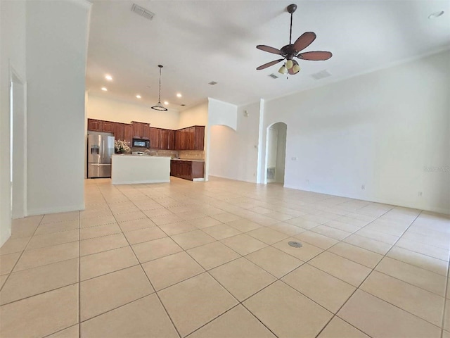 13413 Zori Ln, Windermere, FL 34786 - unfurnished living room with arched walkways, ceiling fan, light tile patterned floors, and recessed lighting