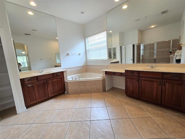 13413 Zori Ln, Windermere, FL 34786 - full bathroom with healthy amount of natural light, two vanities, a garden tub, and recessed lighting