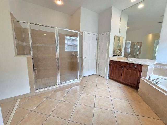 13413 Zori Ln, Windermere, FL 34786 - full bath featuring vanity, a garden tub, a shower stall, and tile patterned floors