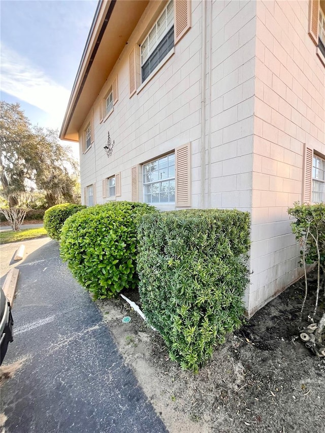 view of property exterior with concrete block siding