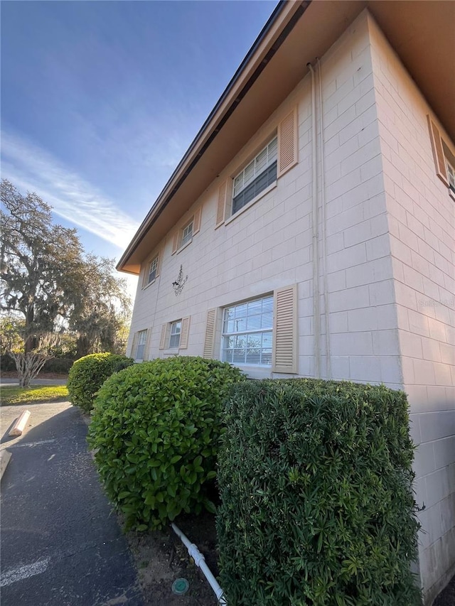 view of side of property with concrete block siding