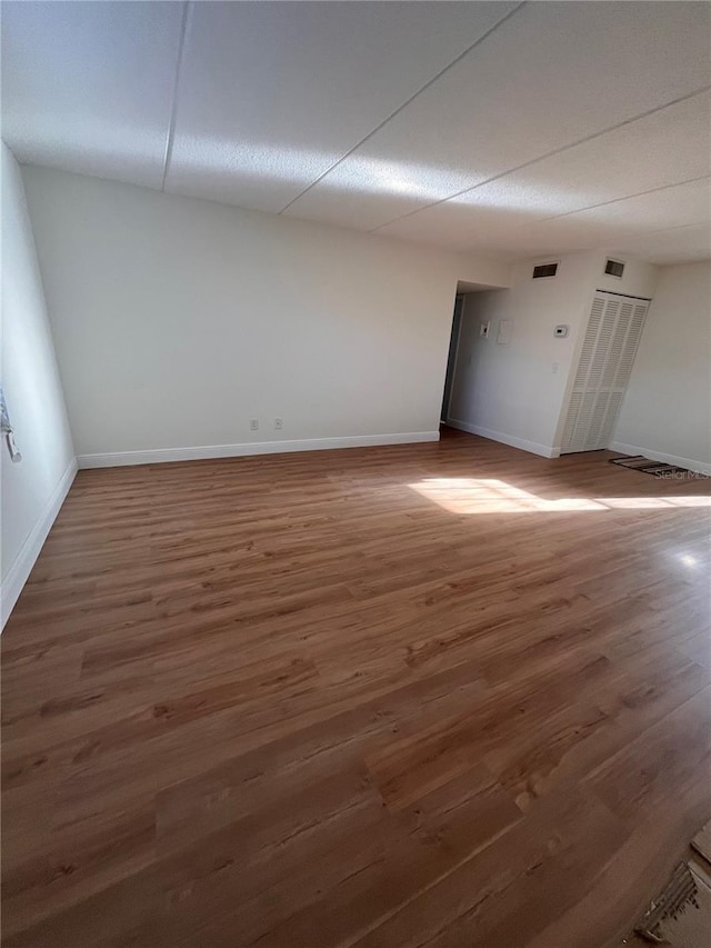 unfurnished room with baseboards and wood finished floors