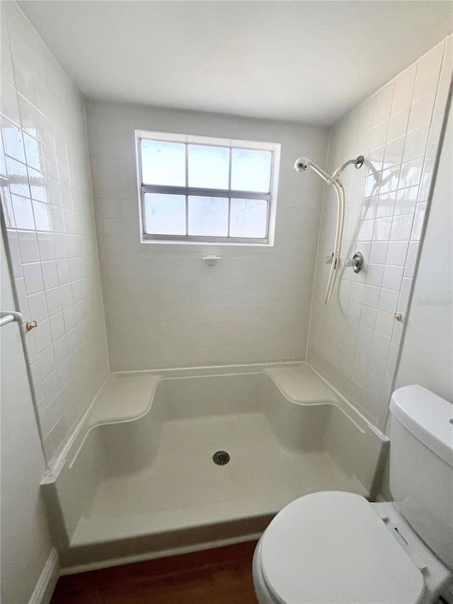 bathroom featuring toilet and a shower