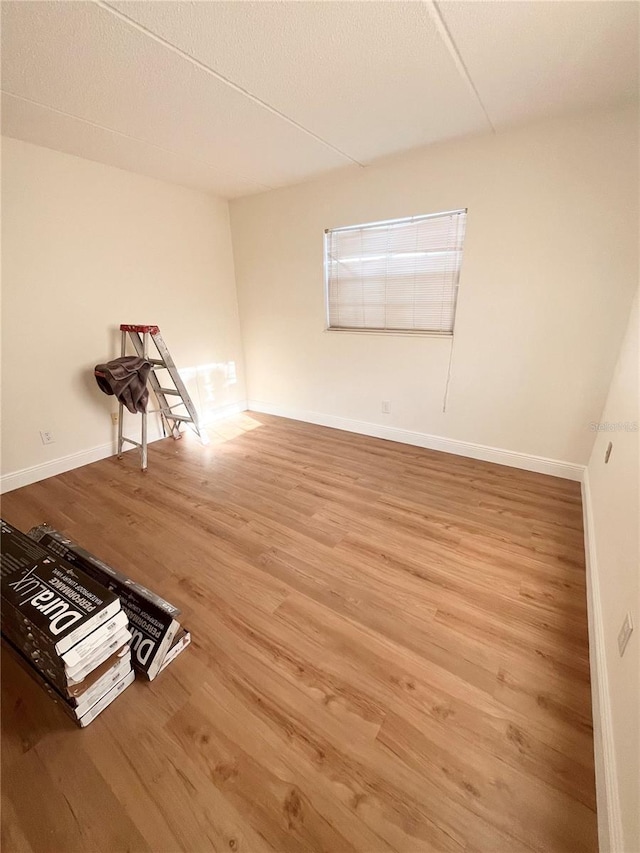 empty room featuring baseboards and wood finished floors