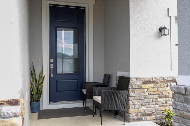 property entrance featuring stucco siding