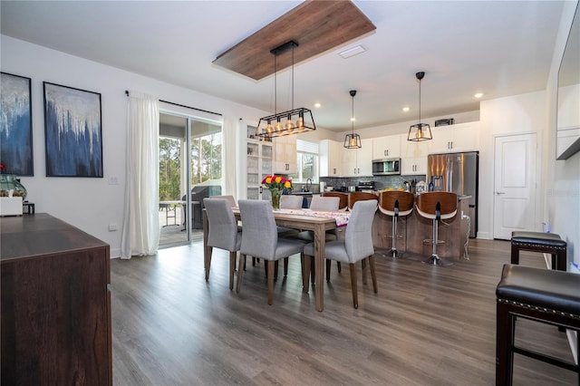 dining space featuring dark wood-type flooring and recessed lighting