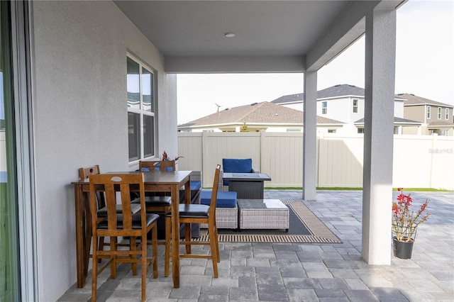 view of patio with outdoor dining area and fence