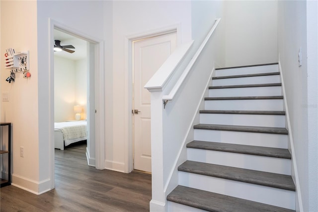 stairs with baseboards and wood finished floors