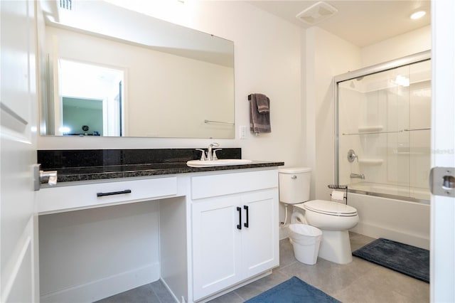 full bathroom with tile patterned flooring, shower / bath combination with glass door, vanity, and toilet