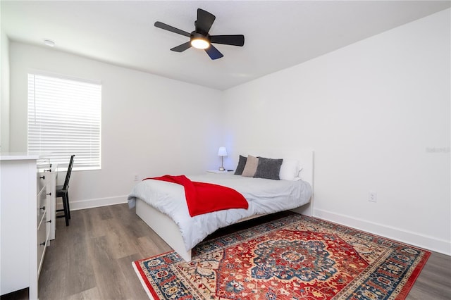 bedroom featuring ceiling fan, wood finished floors, and baseboards