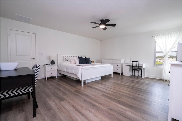 bedroom featuring visible vents, dark wood finished floors, and a ceiling fan