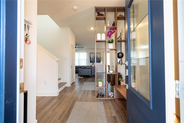 entrance foyer featuring stairway, wood finished floors, and baseboards