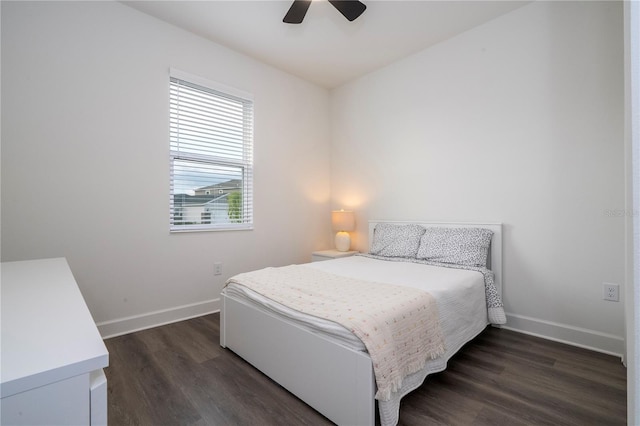 bedroom with ceiling fan, baseboards, and dark wood-style flooring