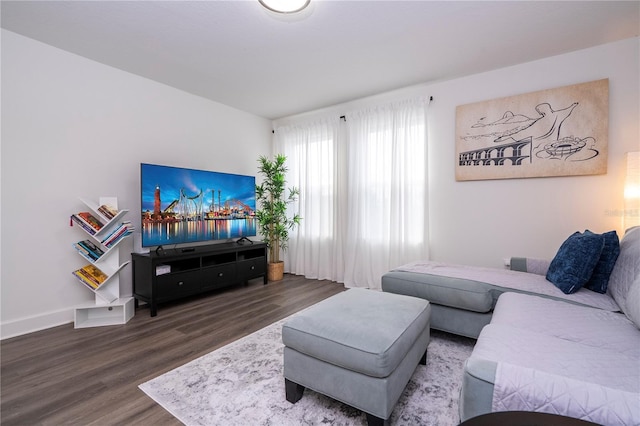 living area with wood finished floors and baseboards