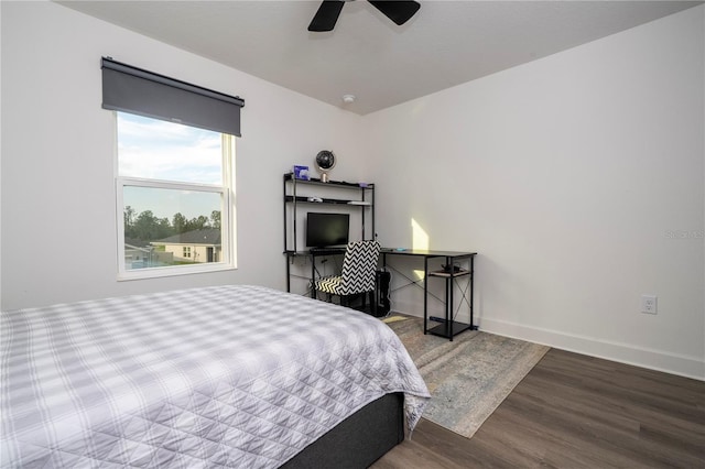 bedroom with a ceiling fan, baseboards, and wood finished floors