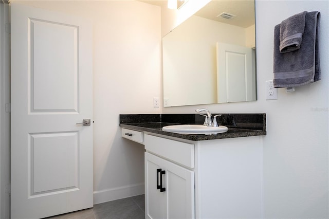 bathroom with tile patterned flooring, vanity, visible vents, and baseboards