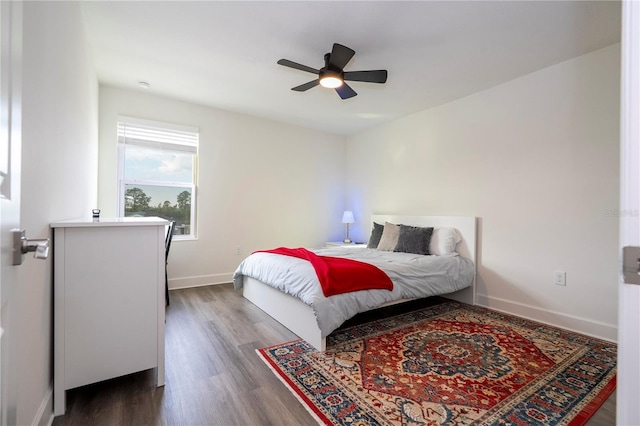 bedroom with ceiling fan, baseboards, and wood finished floors