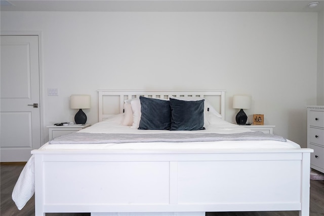 bedroom with dark wood finished floors