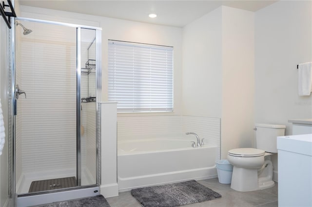 bathroom featuring toilet, a garden tub, tile patterned flooring, vanity, and a shower stall